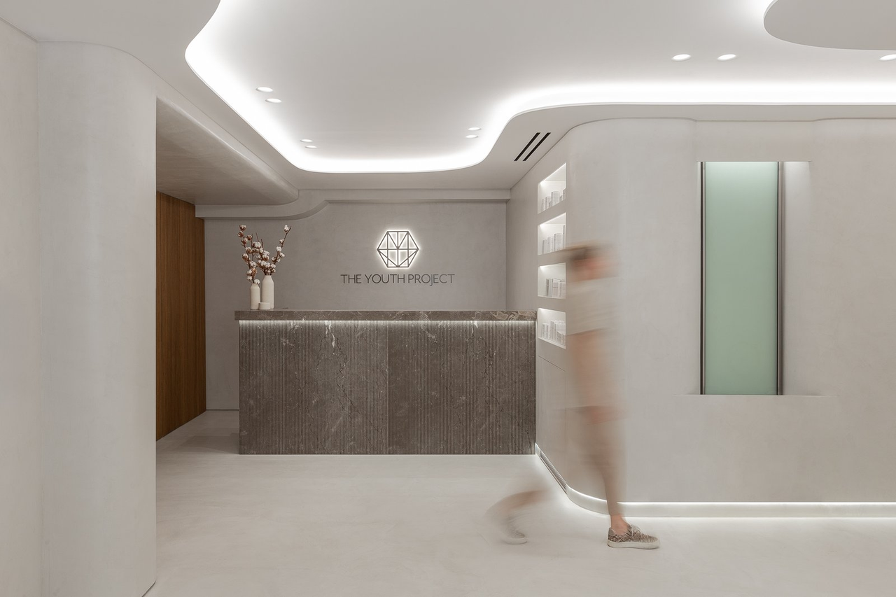 Reception under a curved, softly lit ceiling